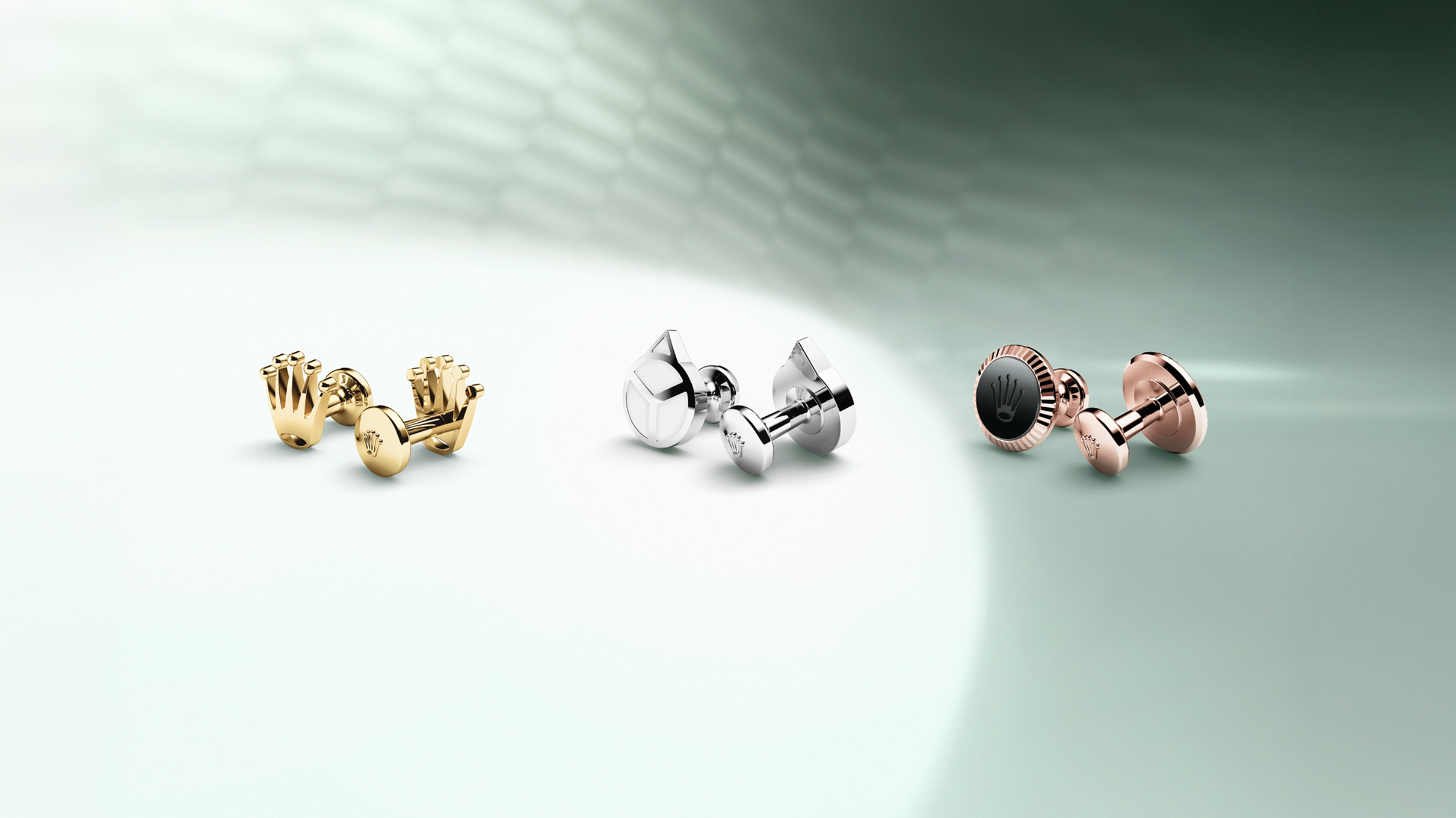 Rolex Three cufflinks in 18 ct yellow, white, and Everose gold.