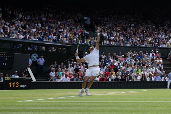 Carlos Alcaraz serving during a match at Wimbledon.