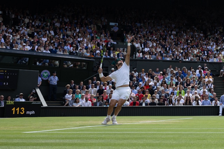 Carlos Alcaraz serving during a match at Wimbledon.
